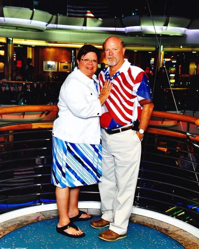 Mike and Betty Tarbuck standing together, smiling, on a cruise ship deck